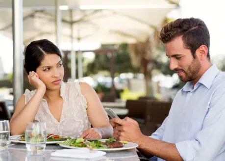 first date mistakes man checking his phone