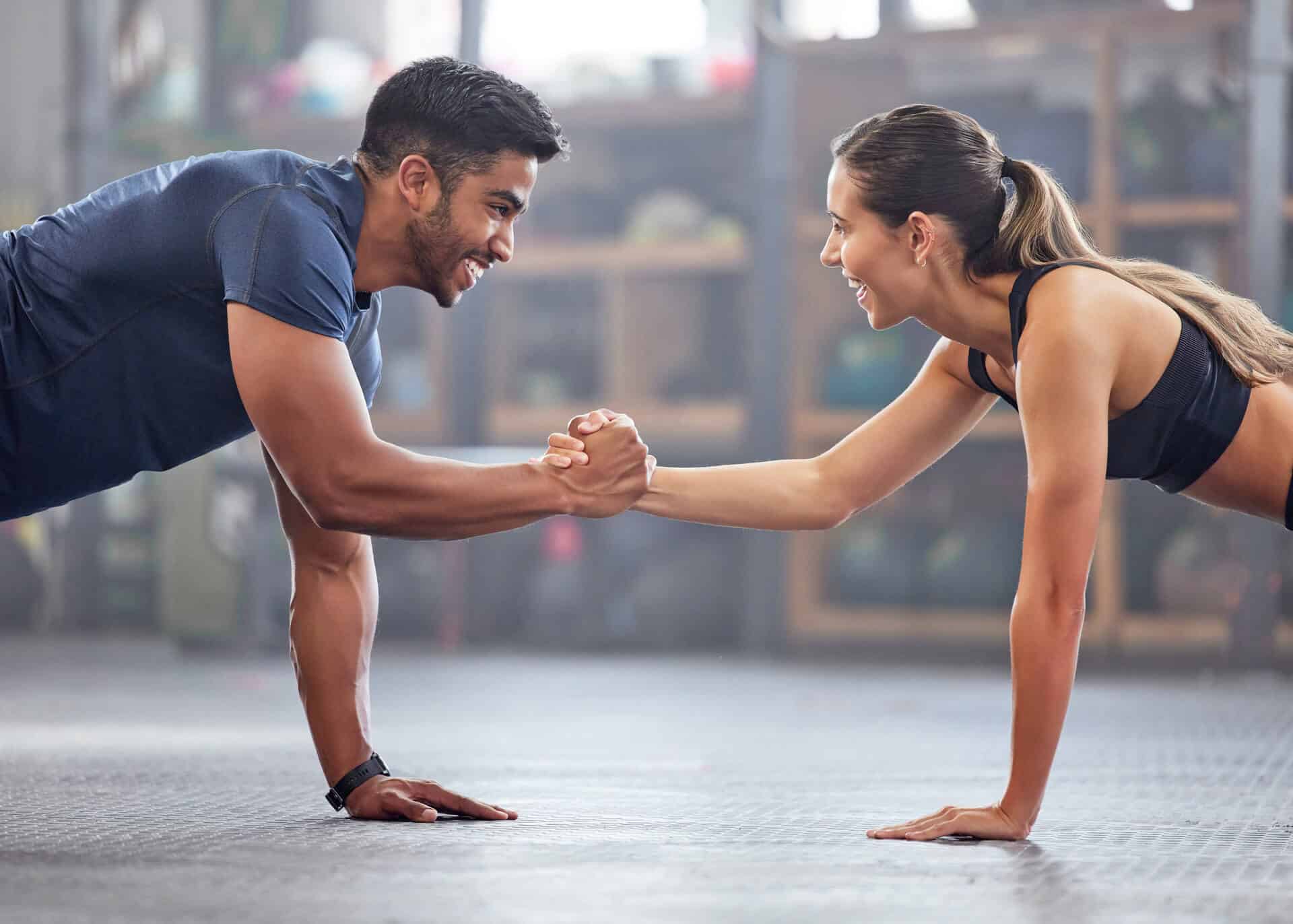 young couple exercising in the gym