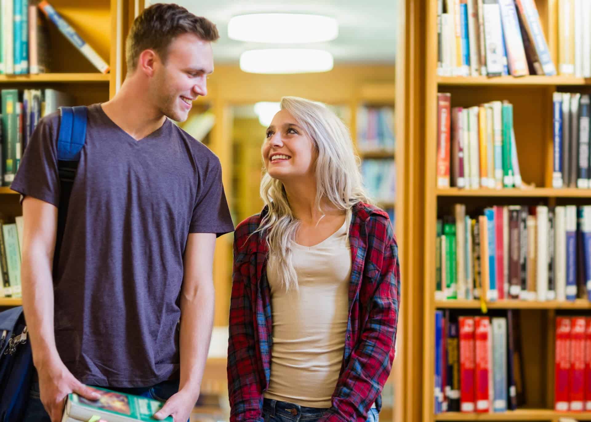 couple looking at each other in the library