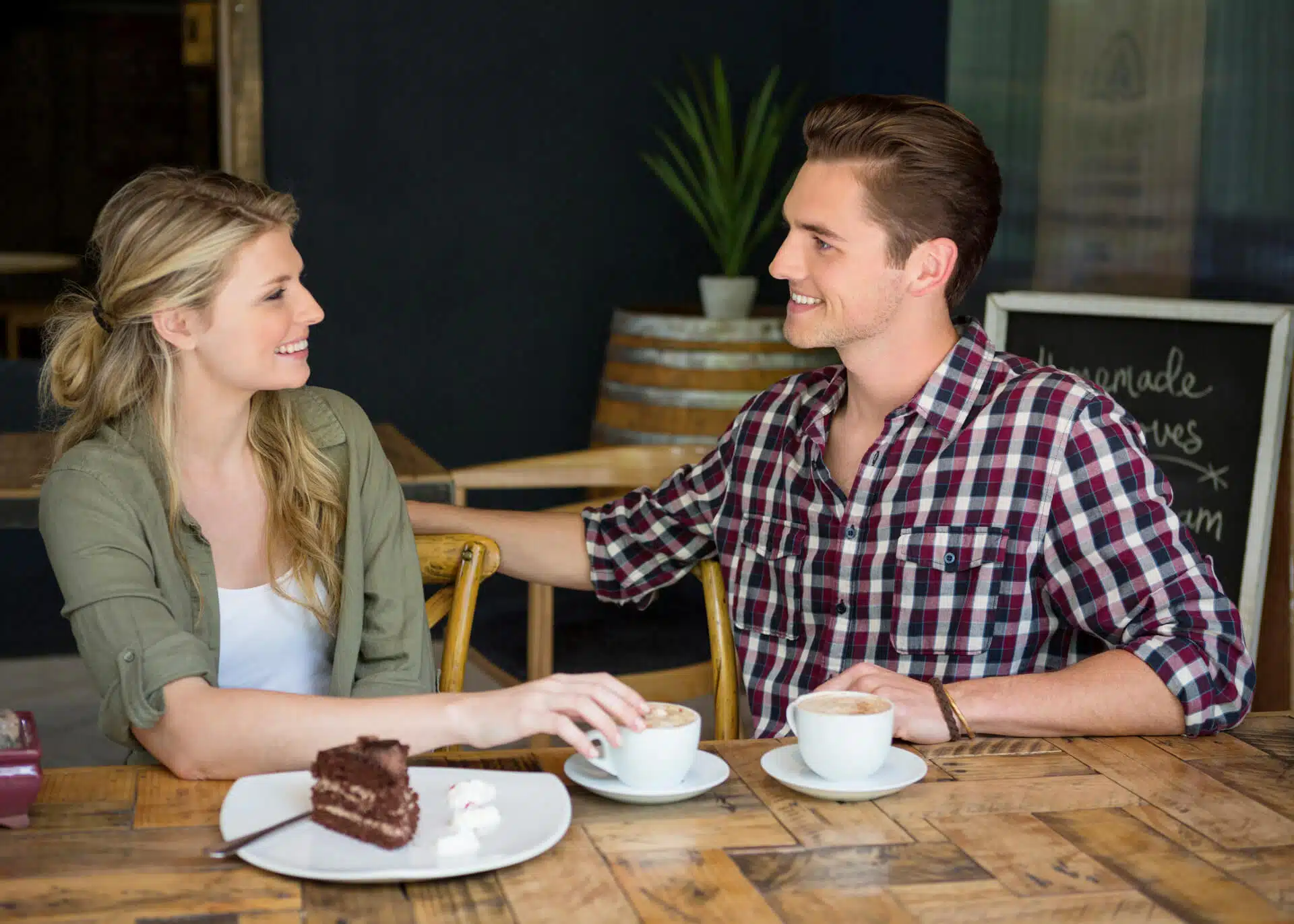 young man admiring woman in coffee shop