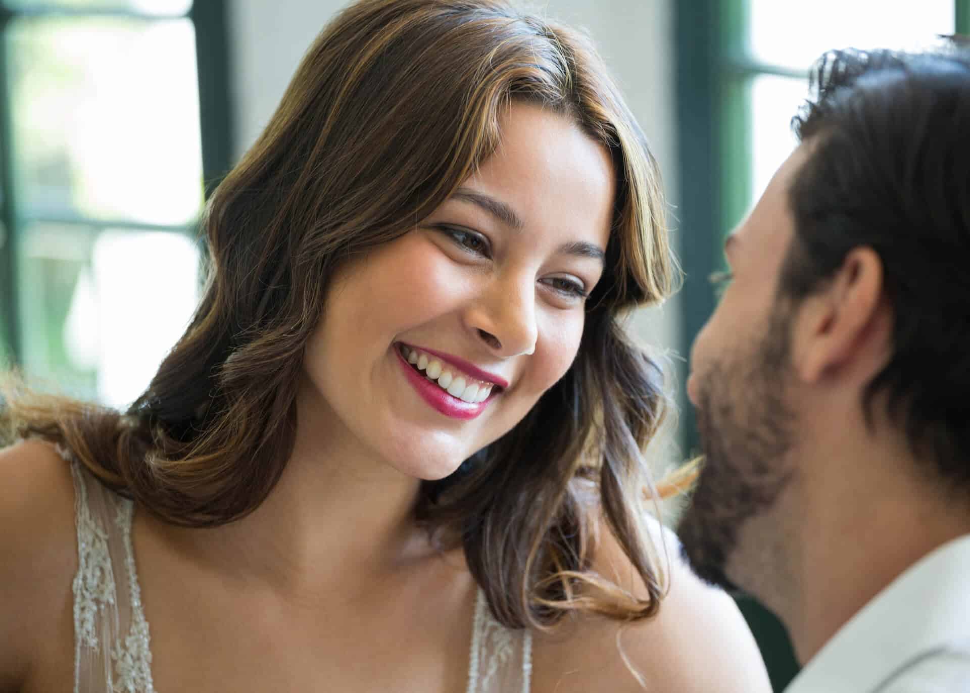 smiling woman looking at man in restaurant