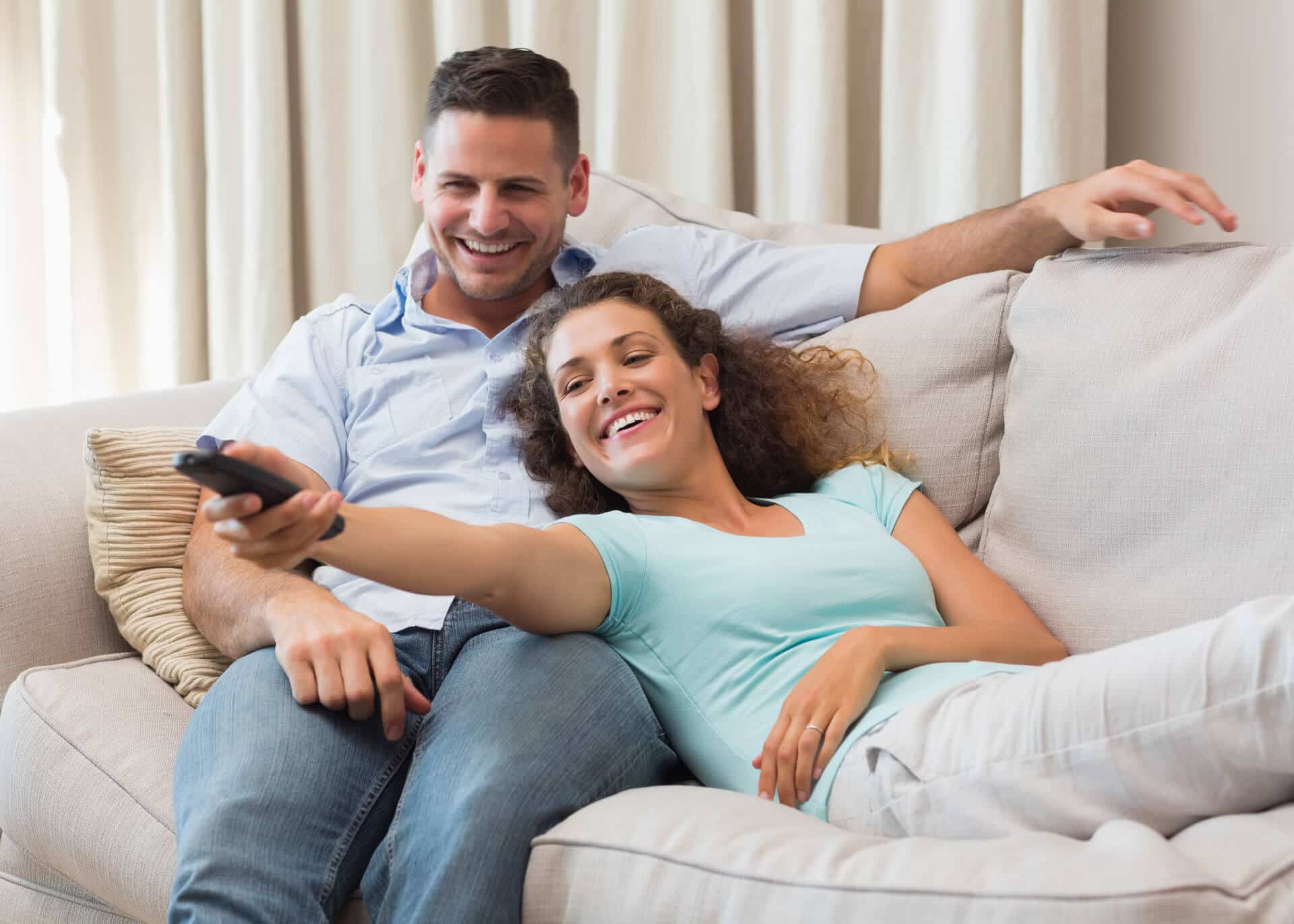 couple watching tv on the couch