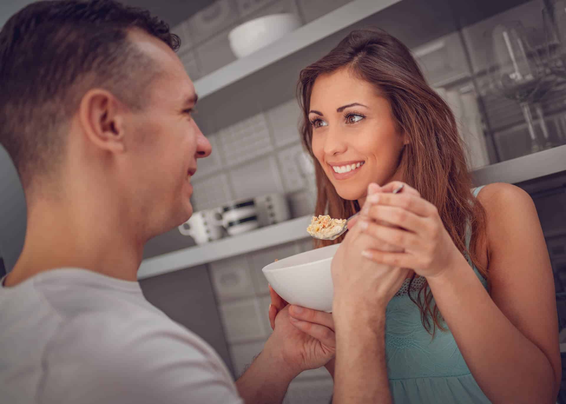 guy sharing his cereal bowl with girlfriend