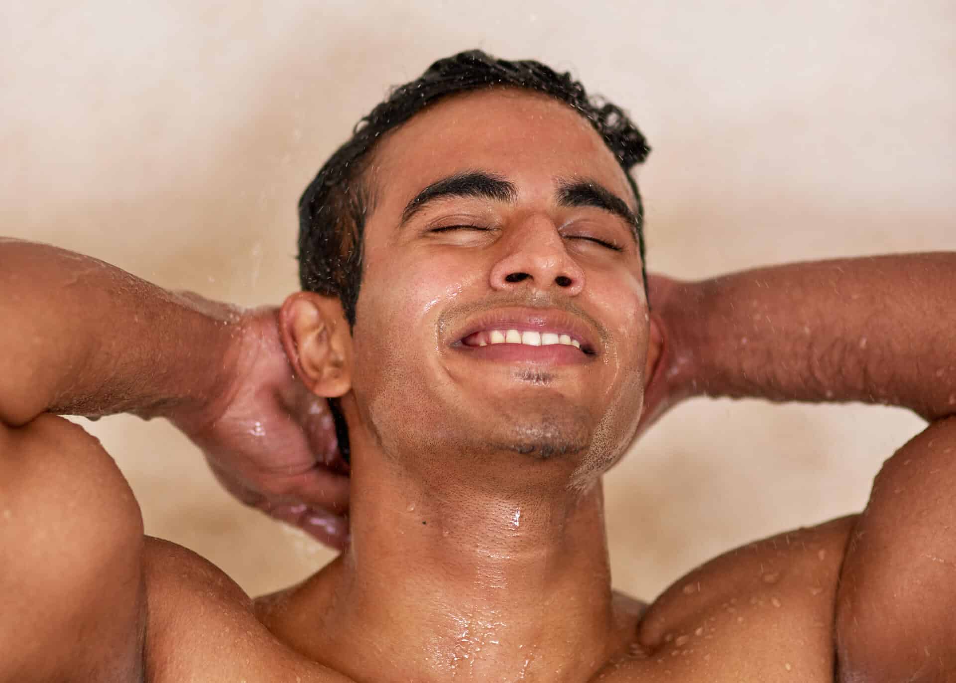 handsome young man enjoying shower
