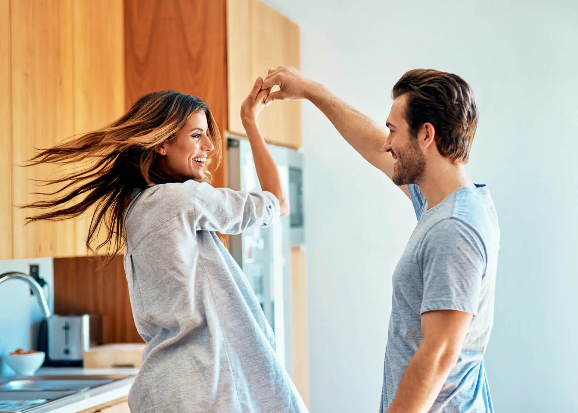 happy young couple dancing at home