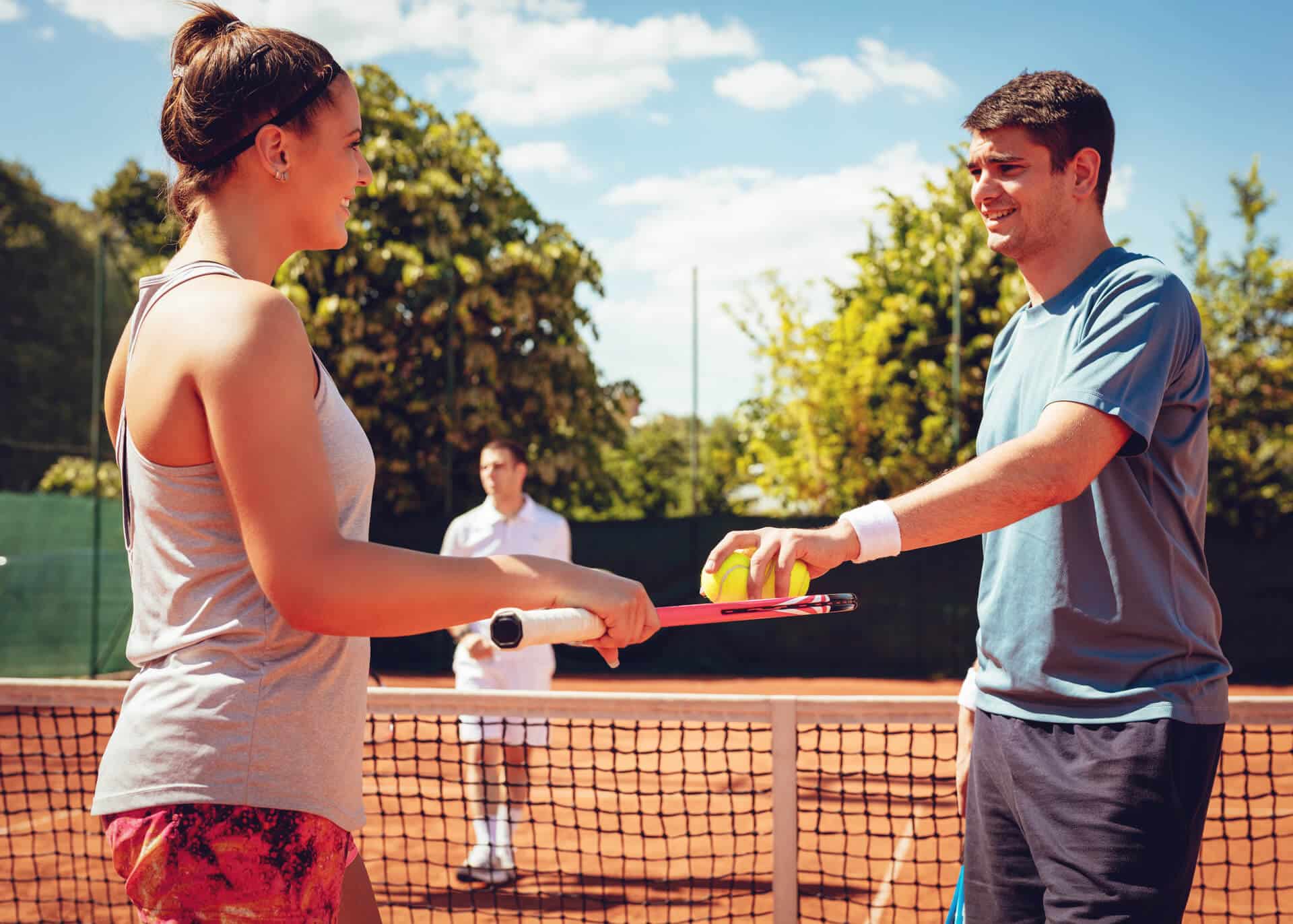 young couple preparing for tennis match