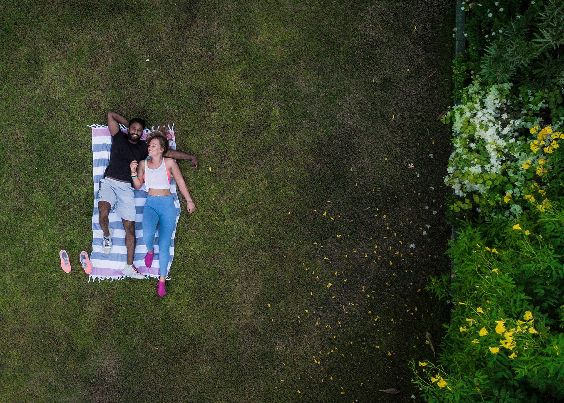 happy couple laying on the grass