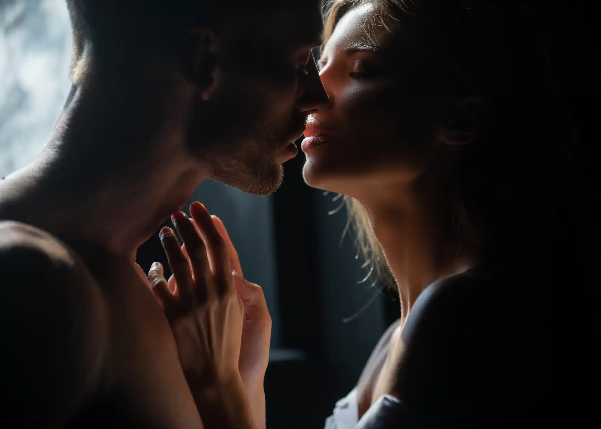 passionate couple kissing in the dark