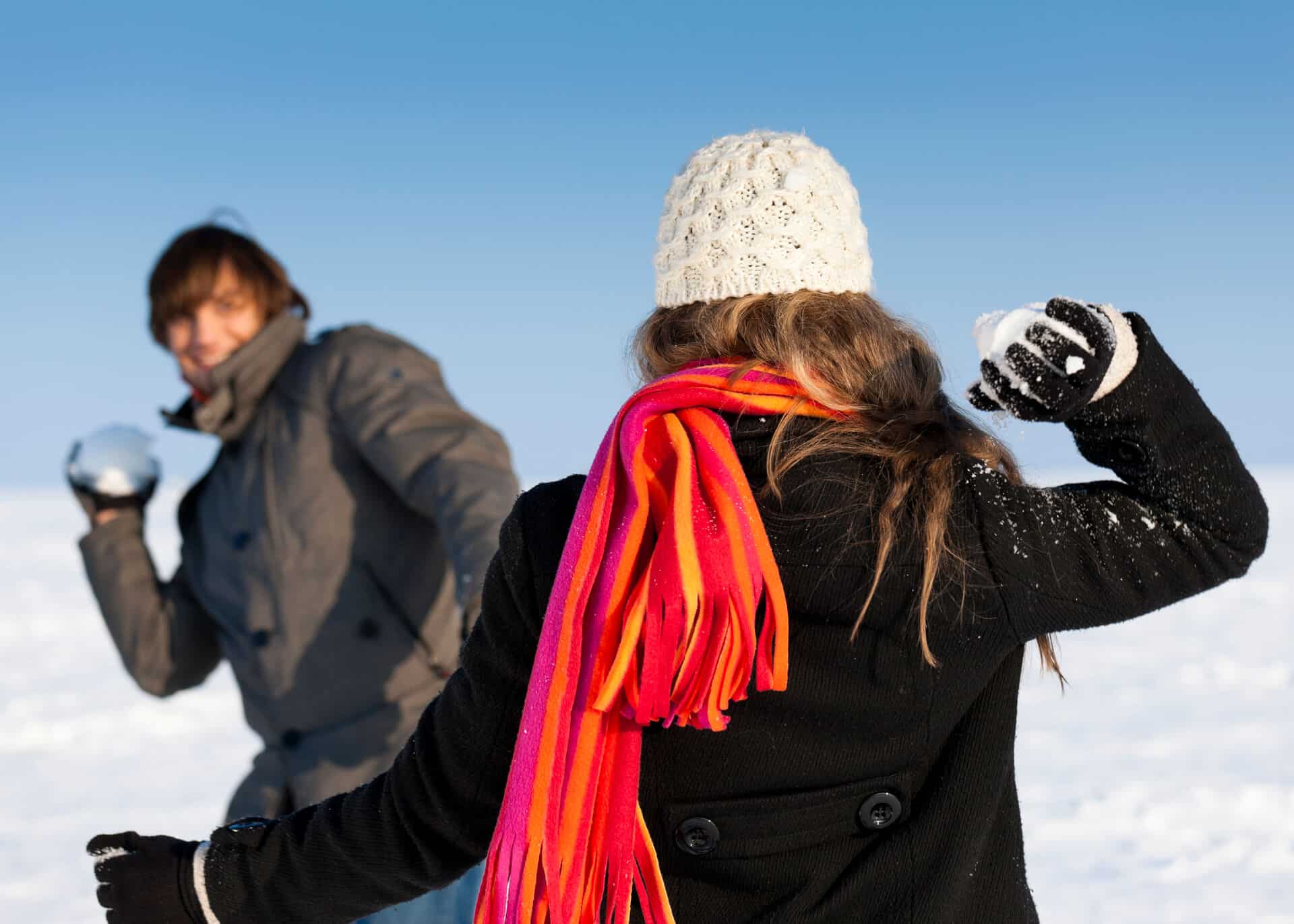 couple playing snowball fight