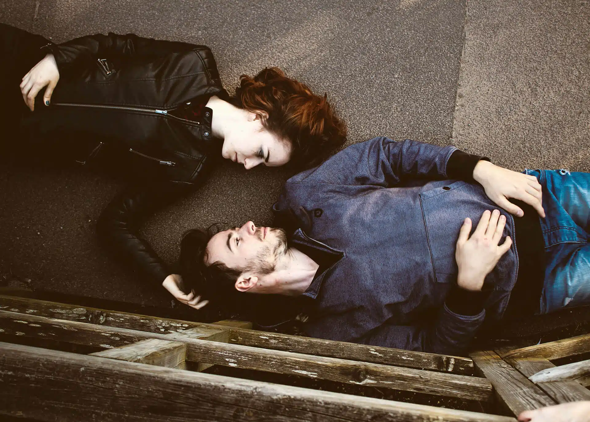 woman and man laying on the ground