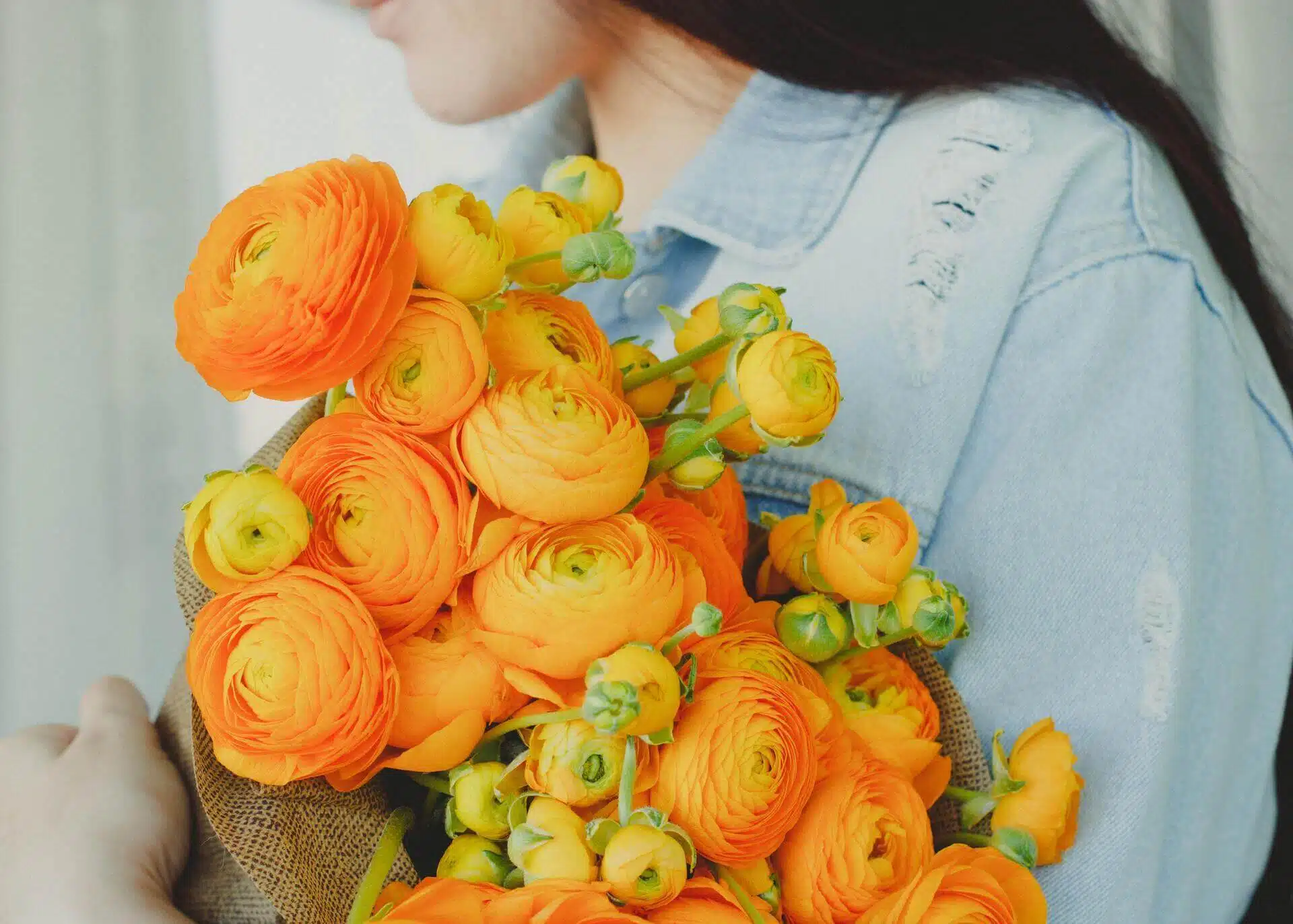 woman holding yellow flower bouquet