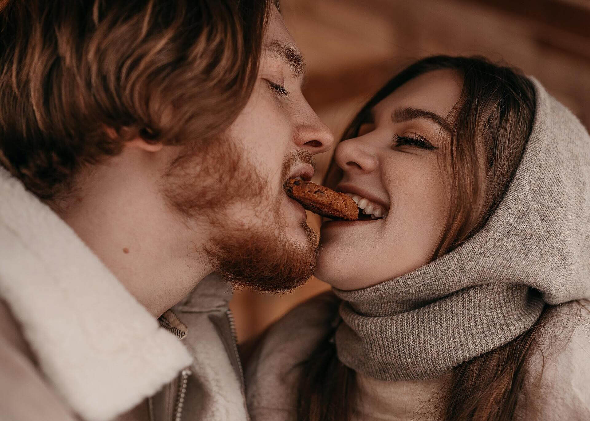 couple biting a cookie together