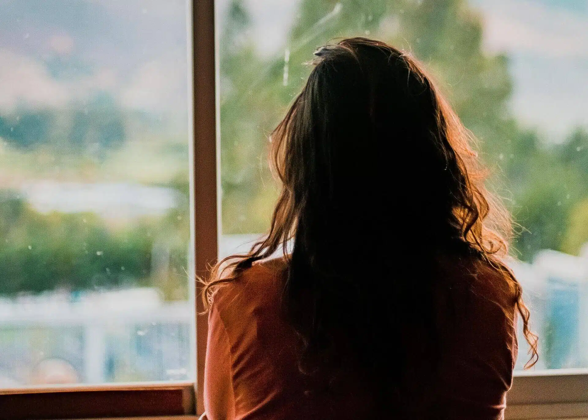 woman looking through the window