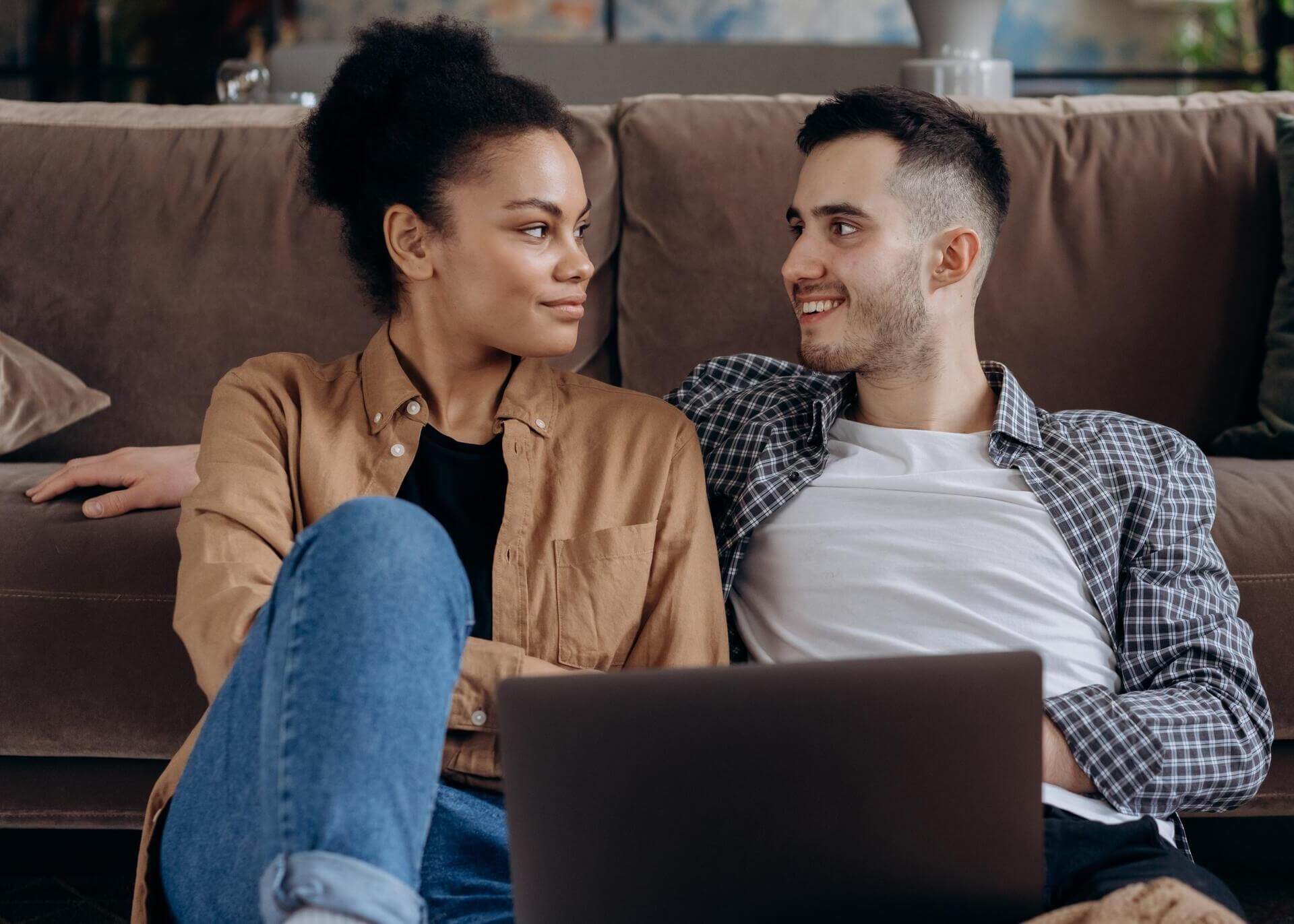 young couple sitting with laptop
