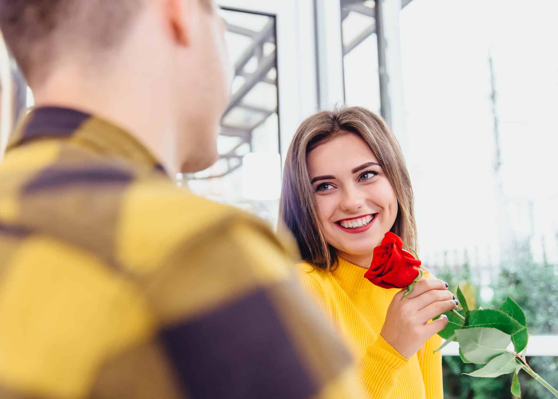 guy gifting a flower to a girl on a date