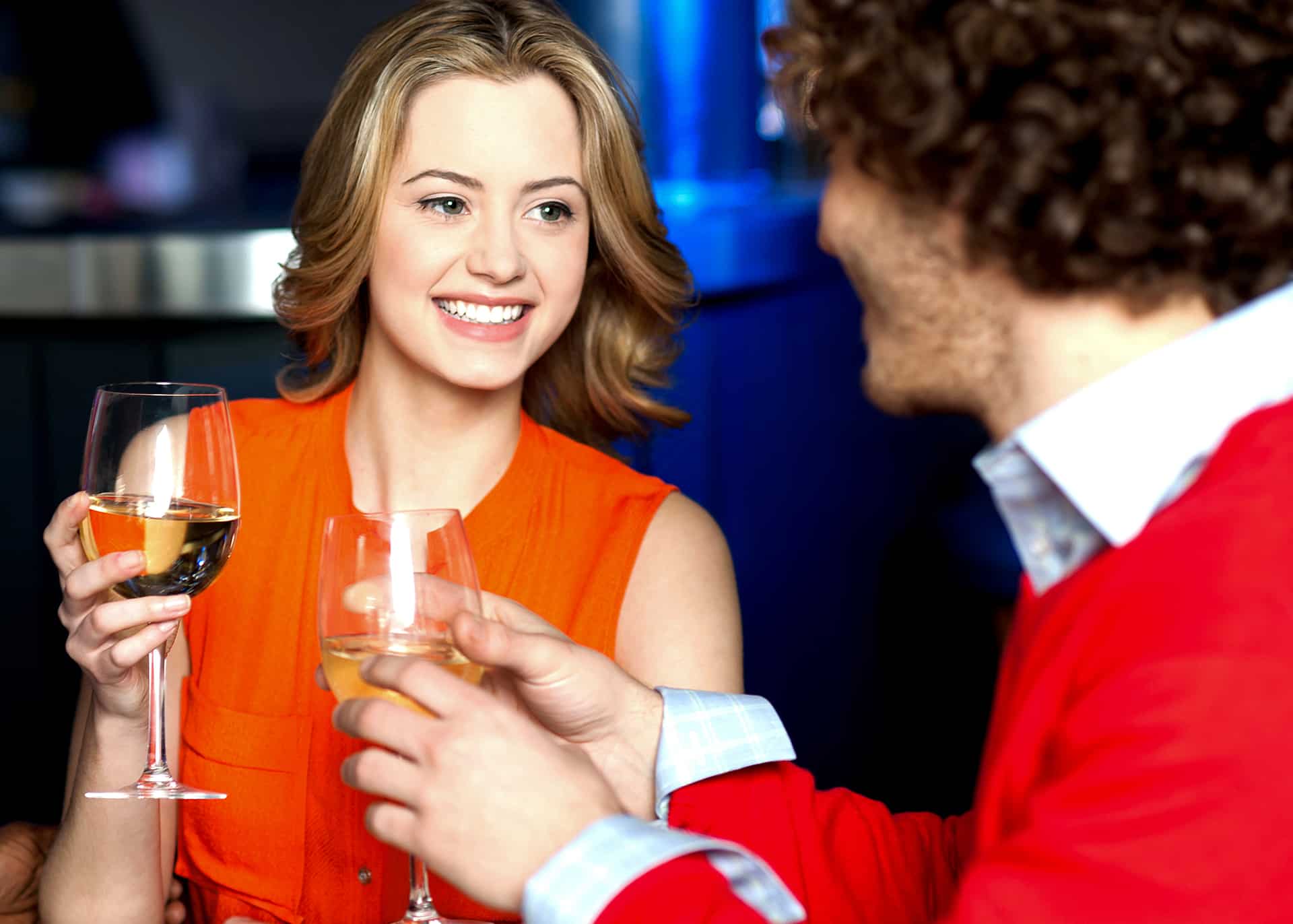 young couple in a bar drinking wine