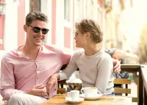 young couple flirting in an outdoor cafe
