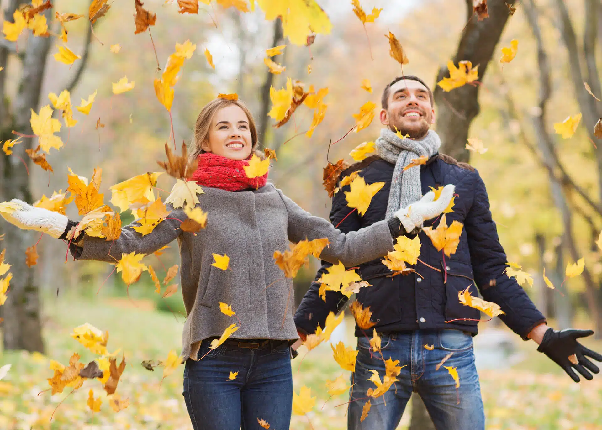 couple in a park playing with leaves