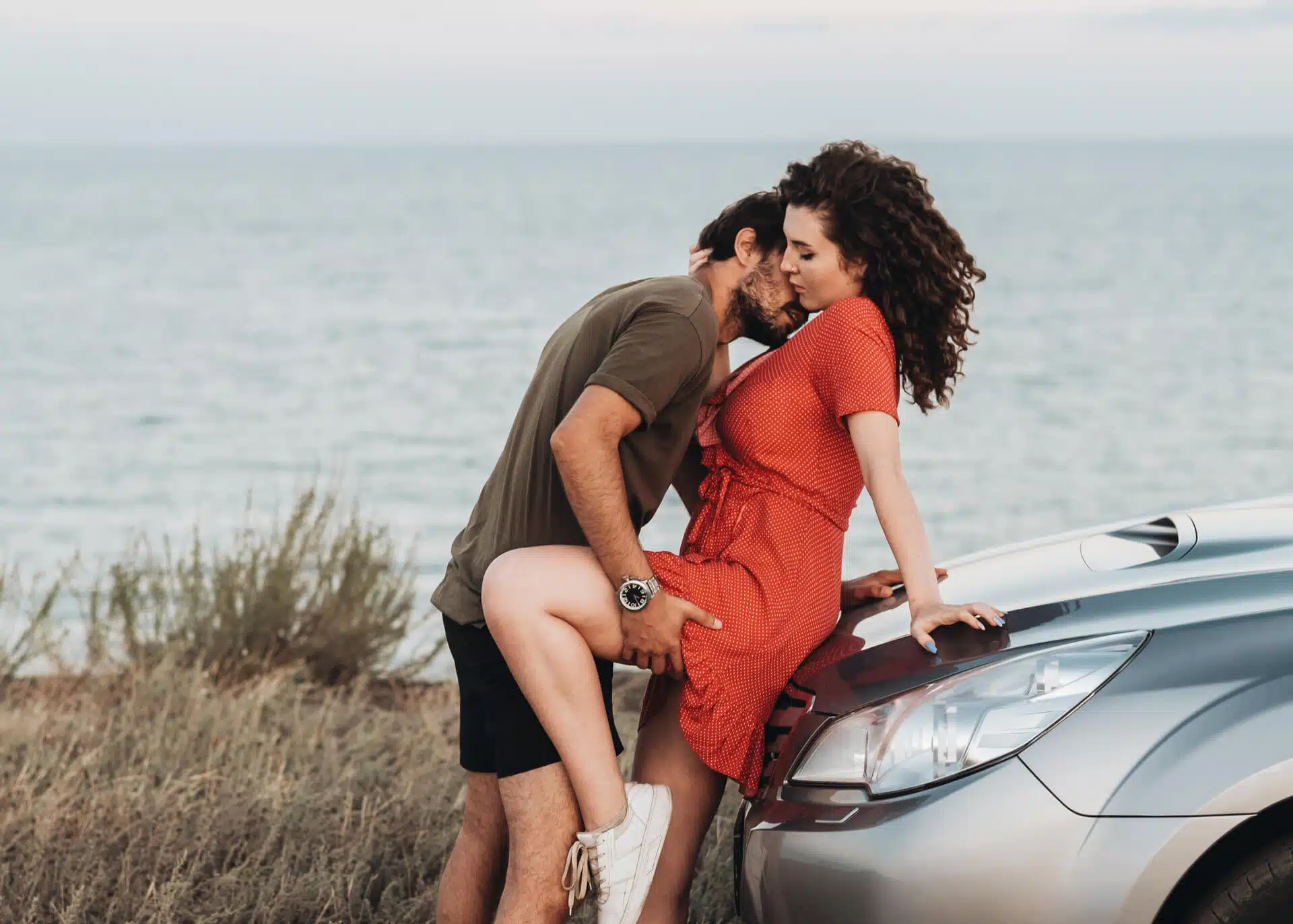 couple making out by their car