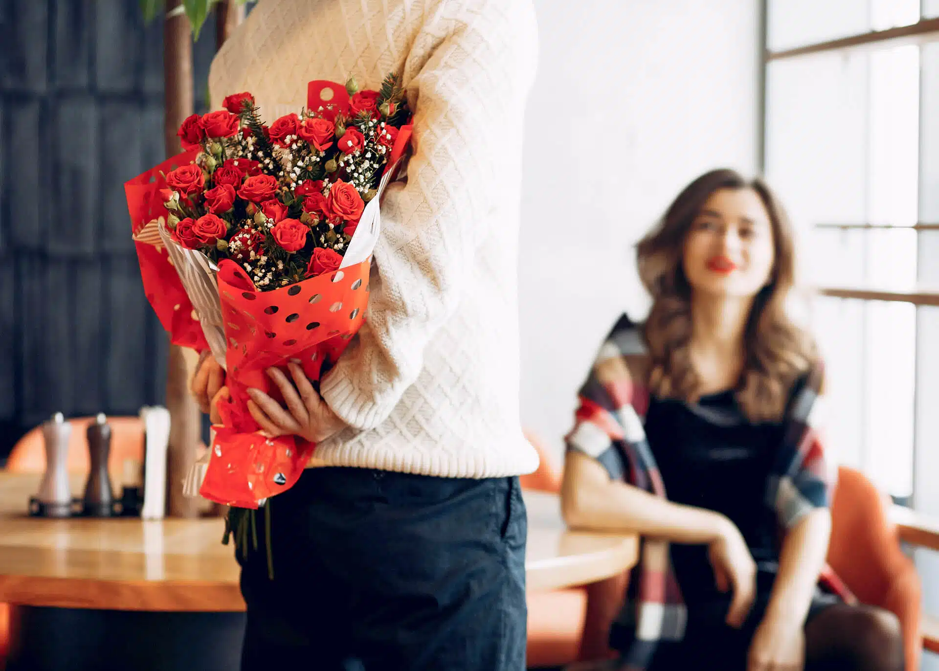 man bringing flowers to a woman on a date