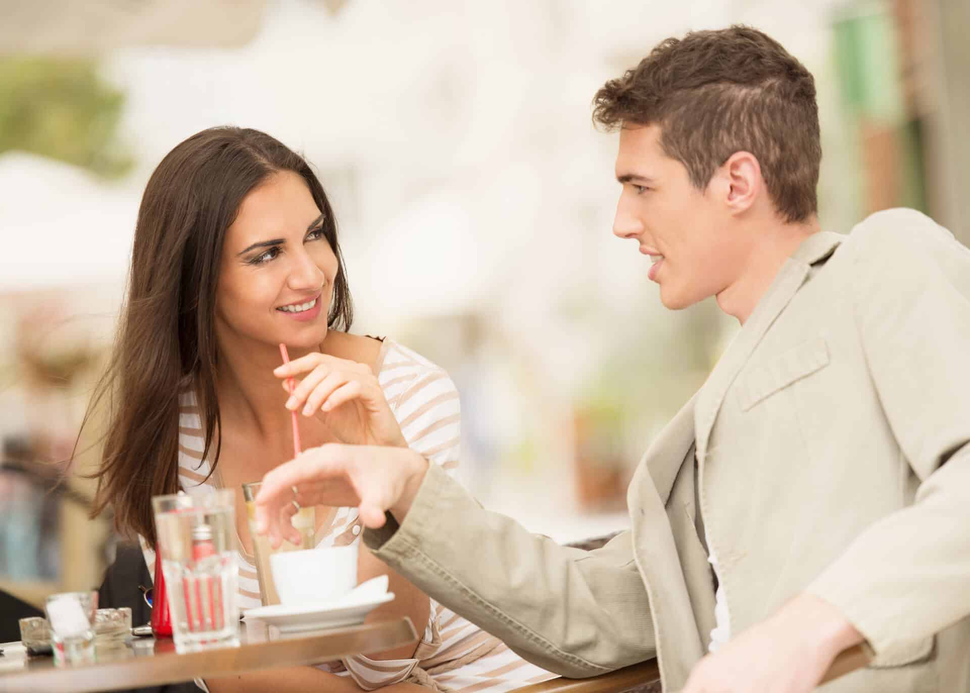 man flirting with a woman in a cafe