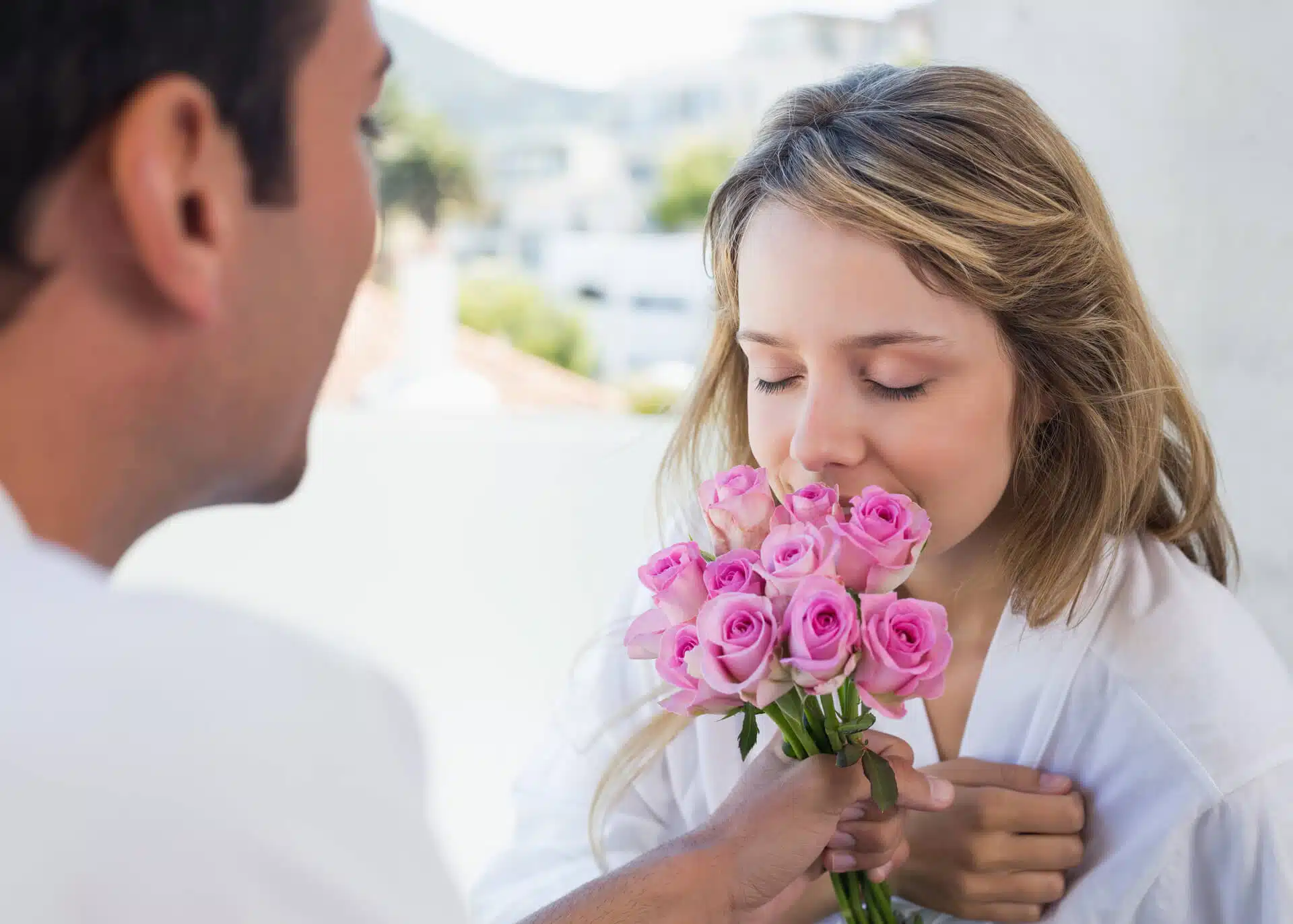 man giving flowers to a woman