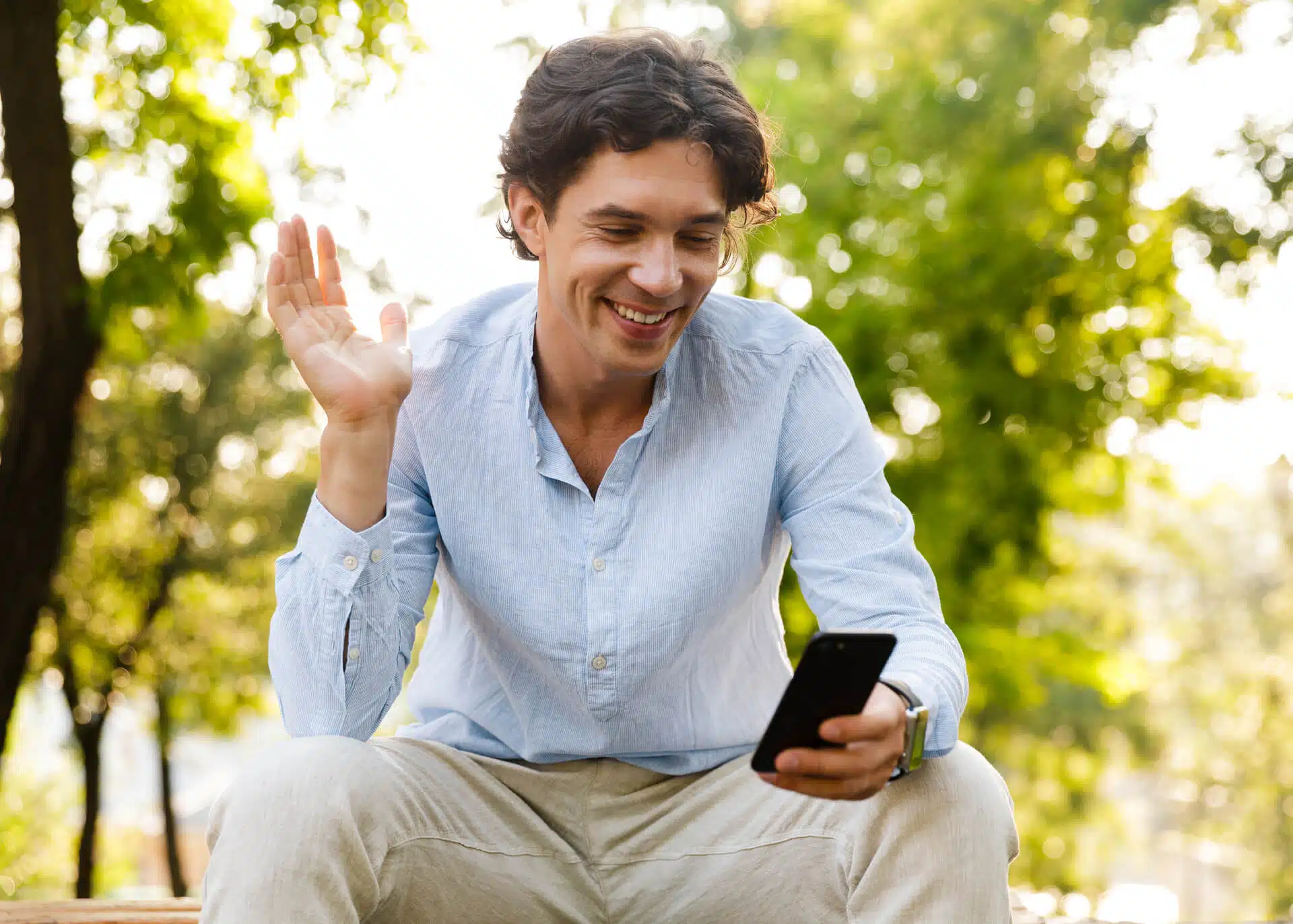 man waving during facetime call