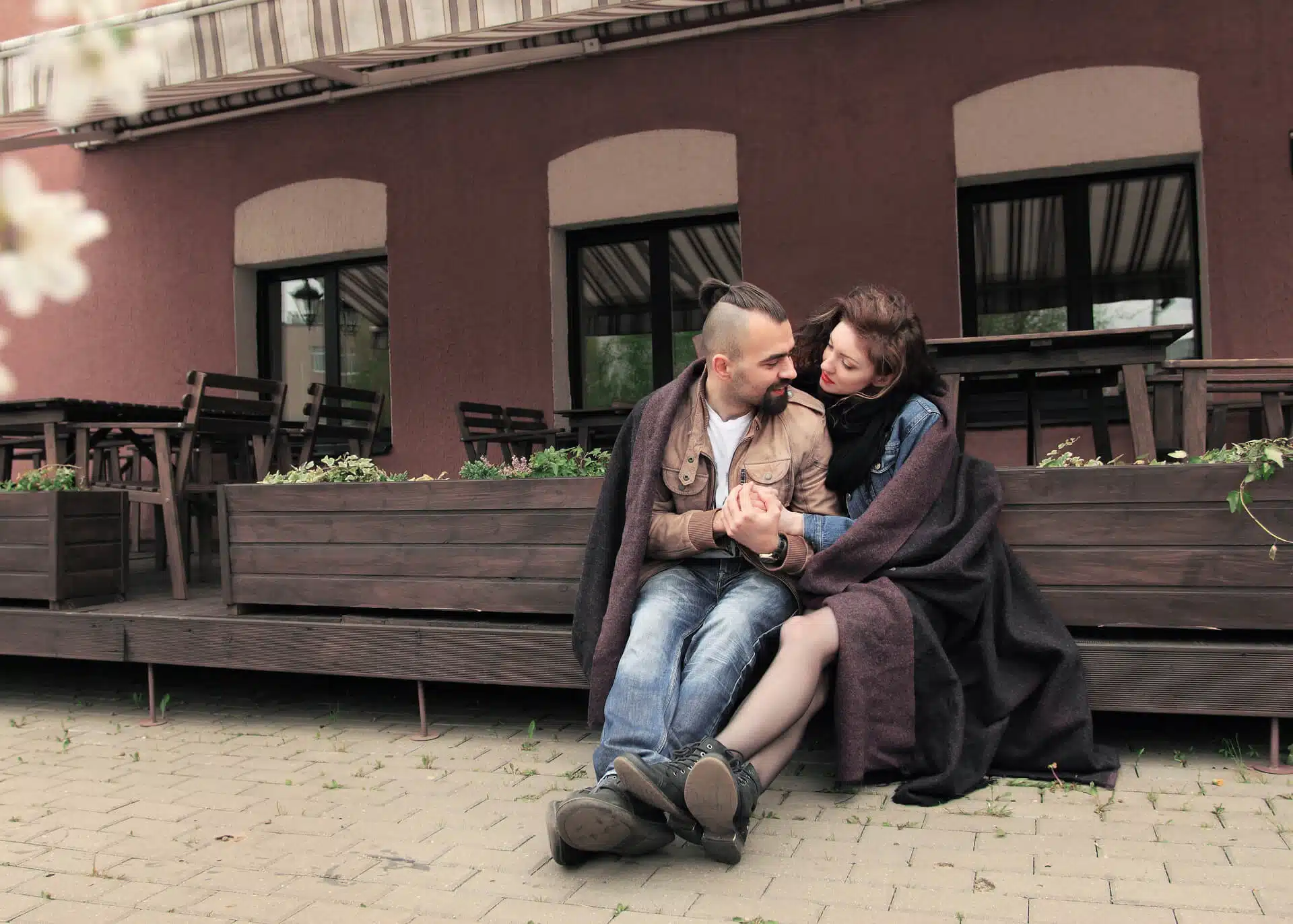 couple sitting outdoors embracing