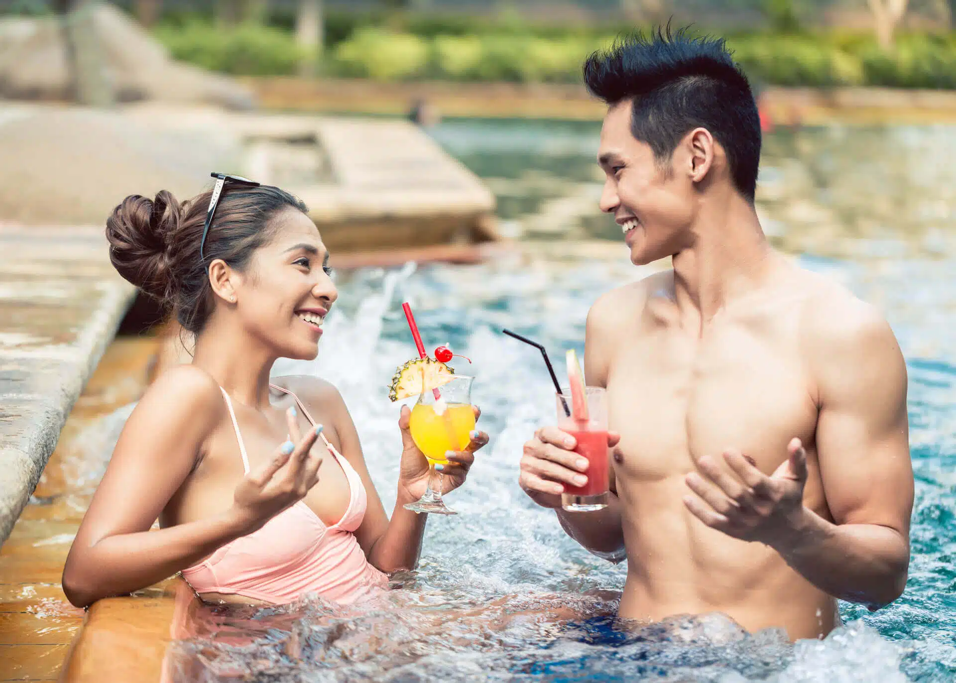 young couple flirting in a pool