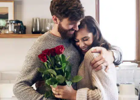 young man giving flowers to a woman