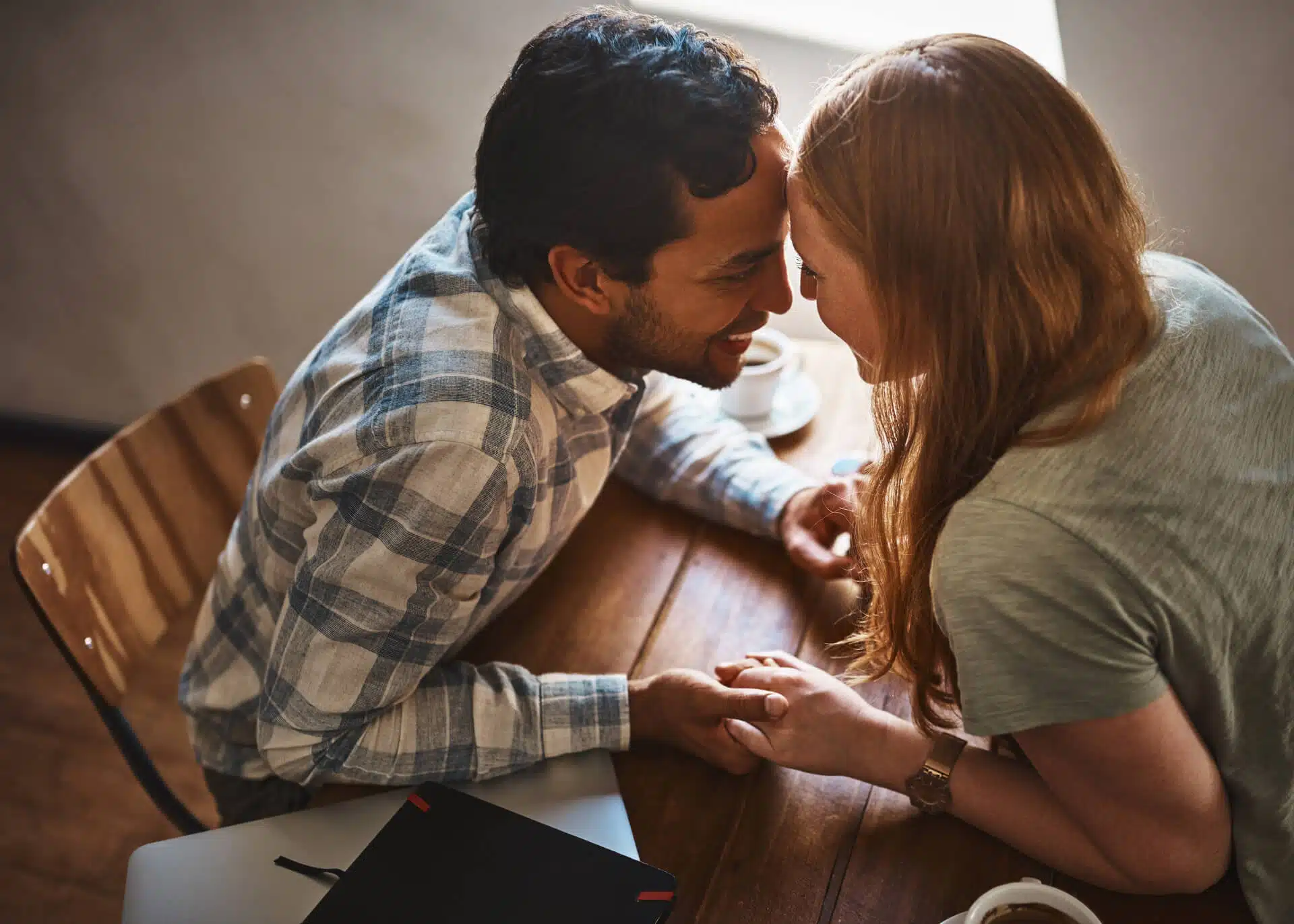 couple in love holding hands sitting at the table