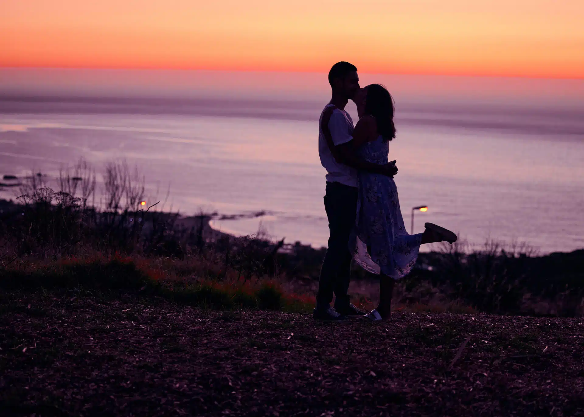 couple kissing at sunset