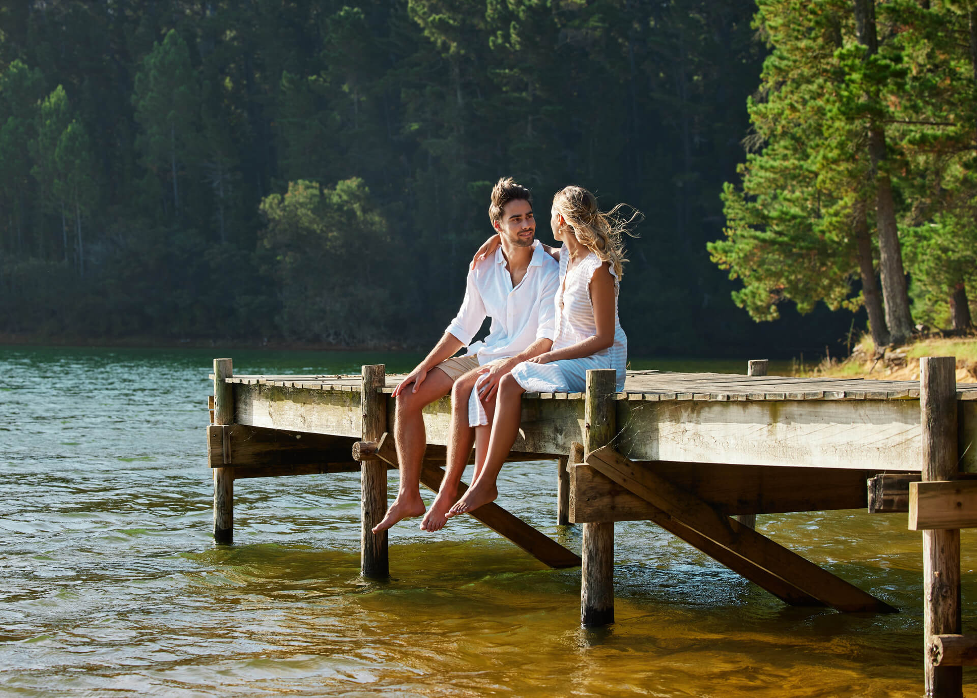 couple sitting at a lake