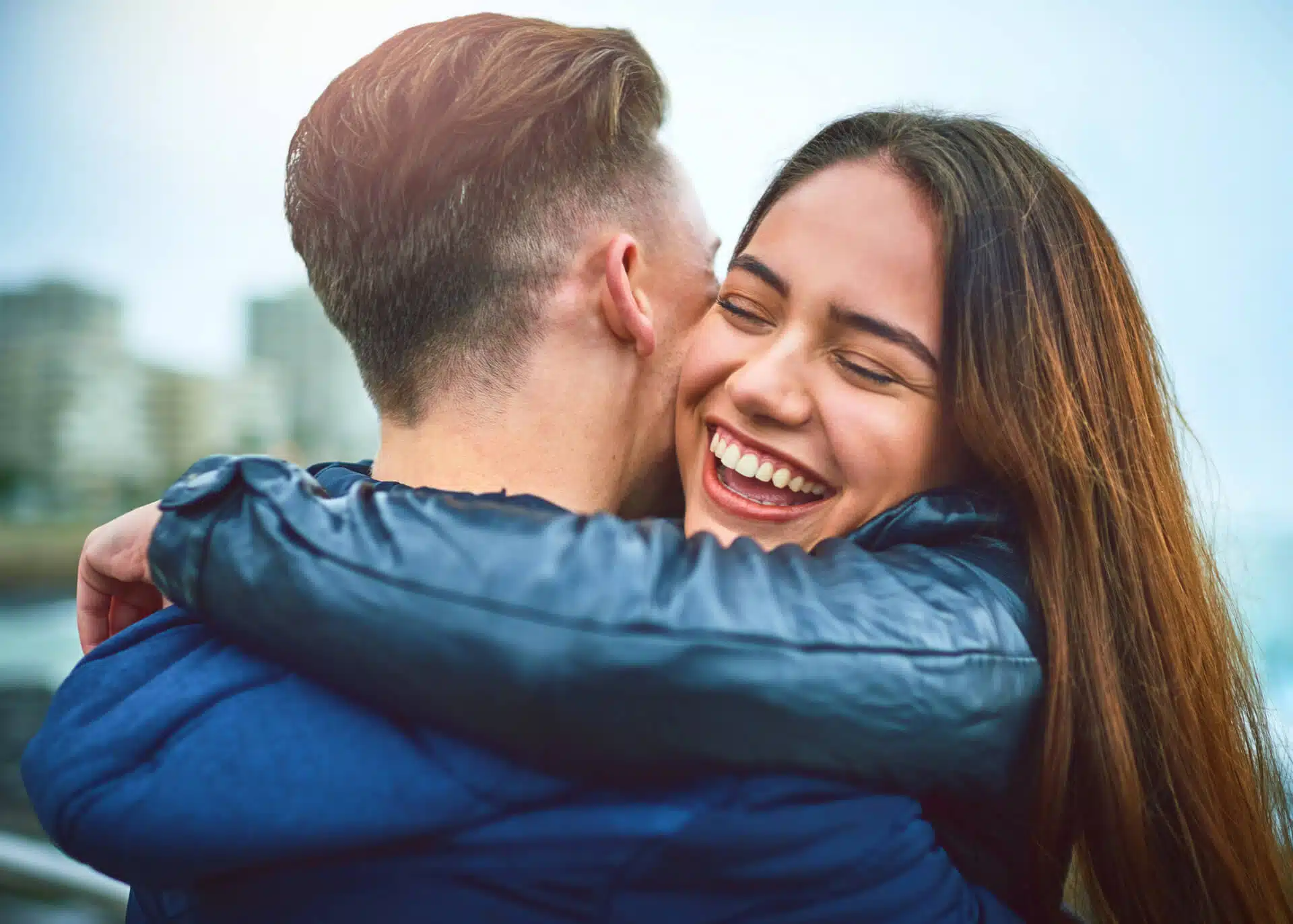 happy couple embracing outdoors