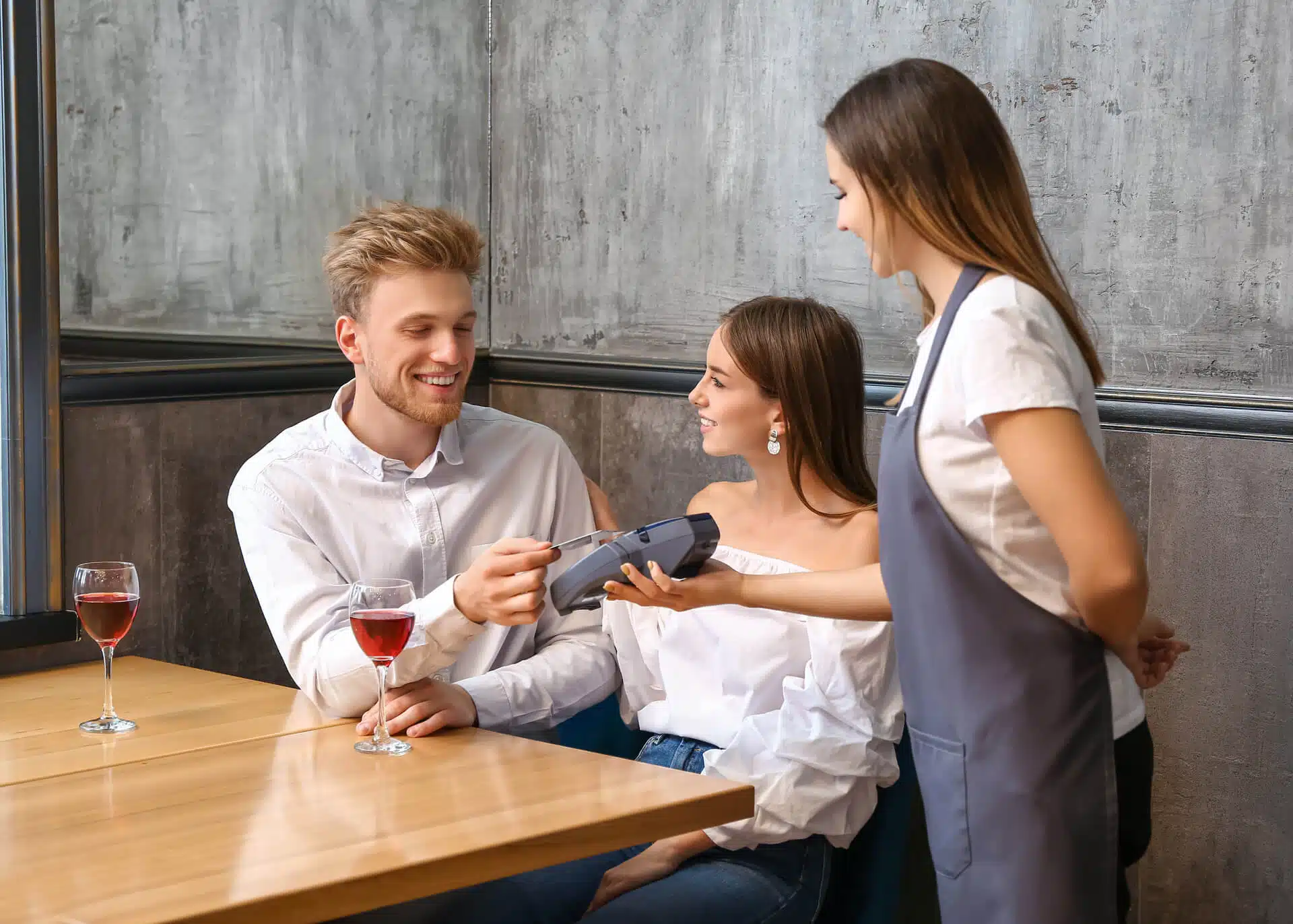 man on a date paying in a restaurant