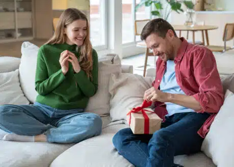 girlfriend giving a gift to gemini man